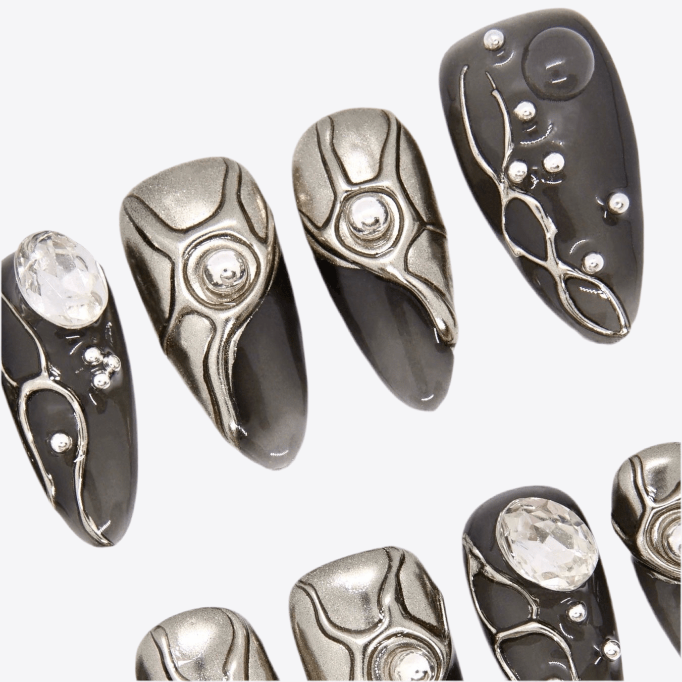 Close-up of handcrafted metallic press-on nails featuring 3D industrial designs.