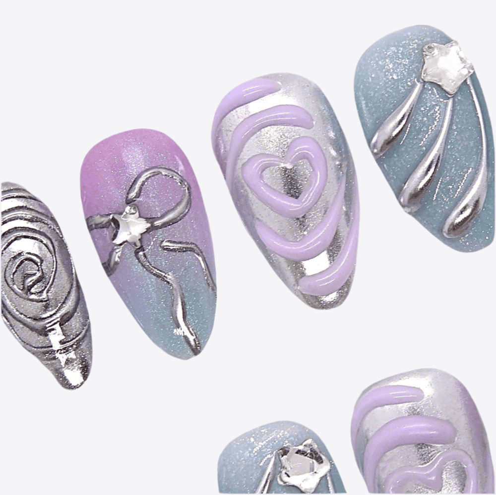 Close-up of 3D chrome swirl embellishments on a lilac base.