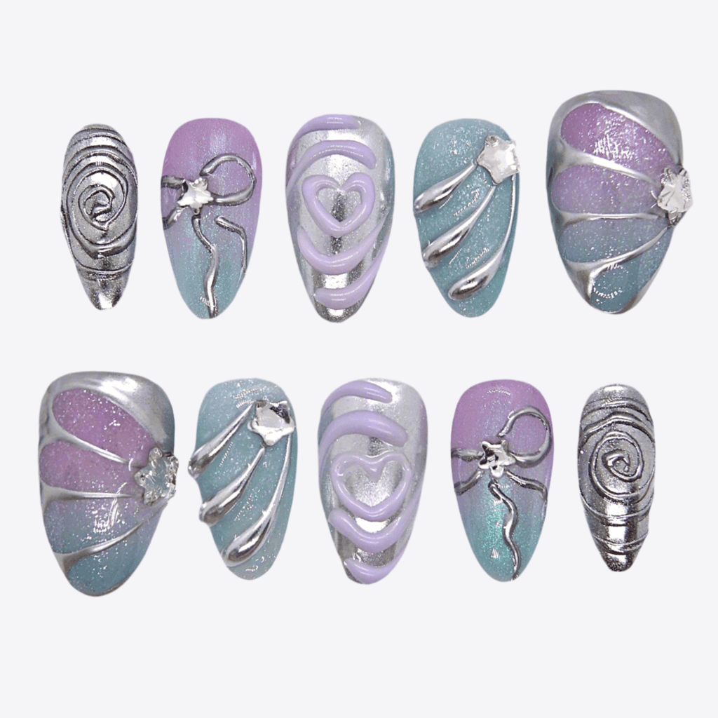 Flat lay of a pastel chrome nail set featuring sculptural silver lines and gradient tones.