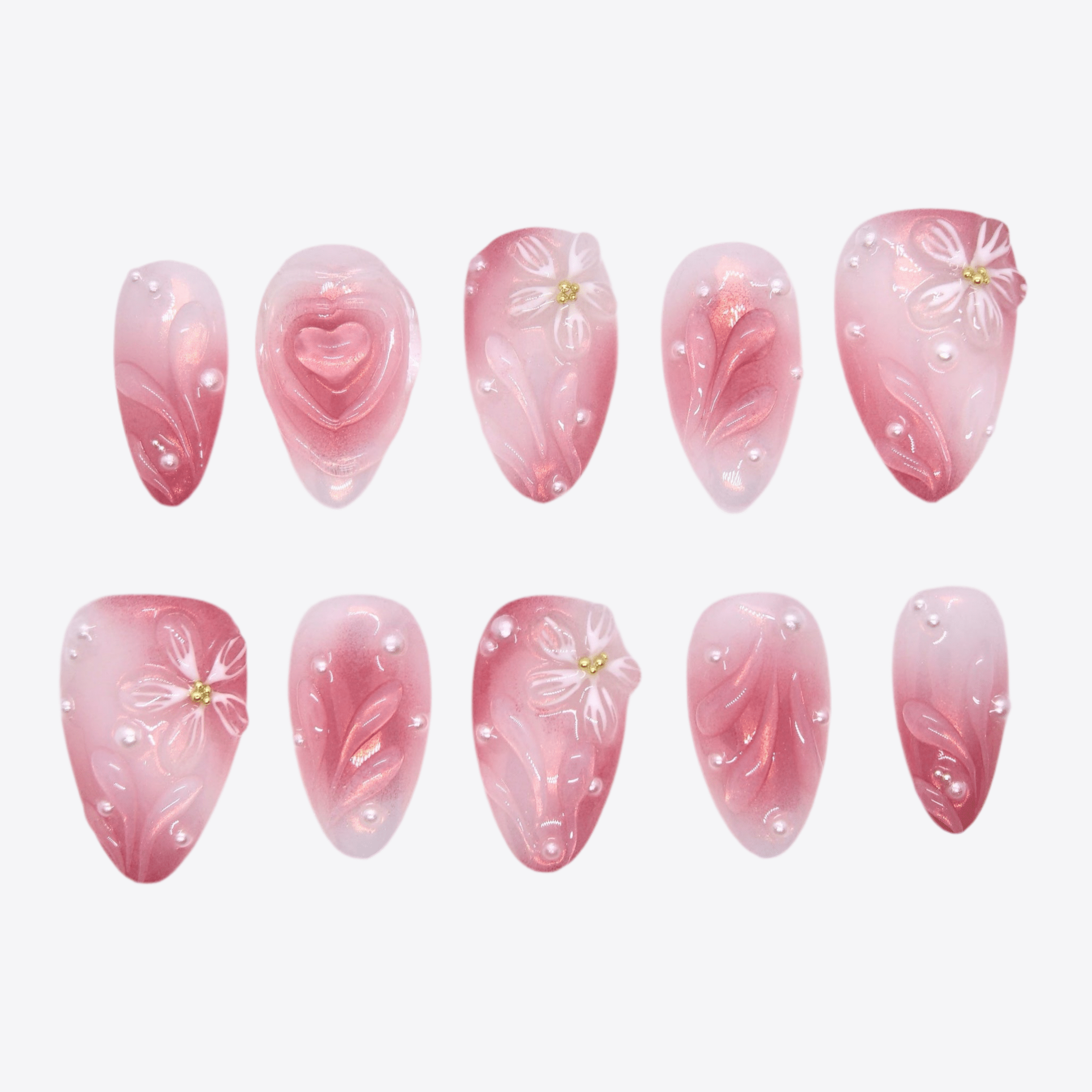 Gradient pink press-on nails with 3D floral details, pearl accents, and heart centerpiece from Sugar Dream Series.