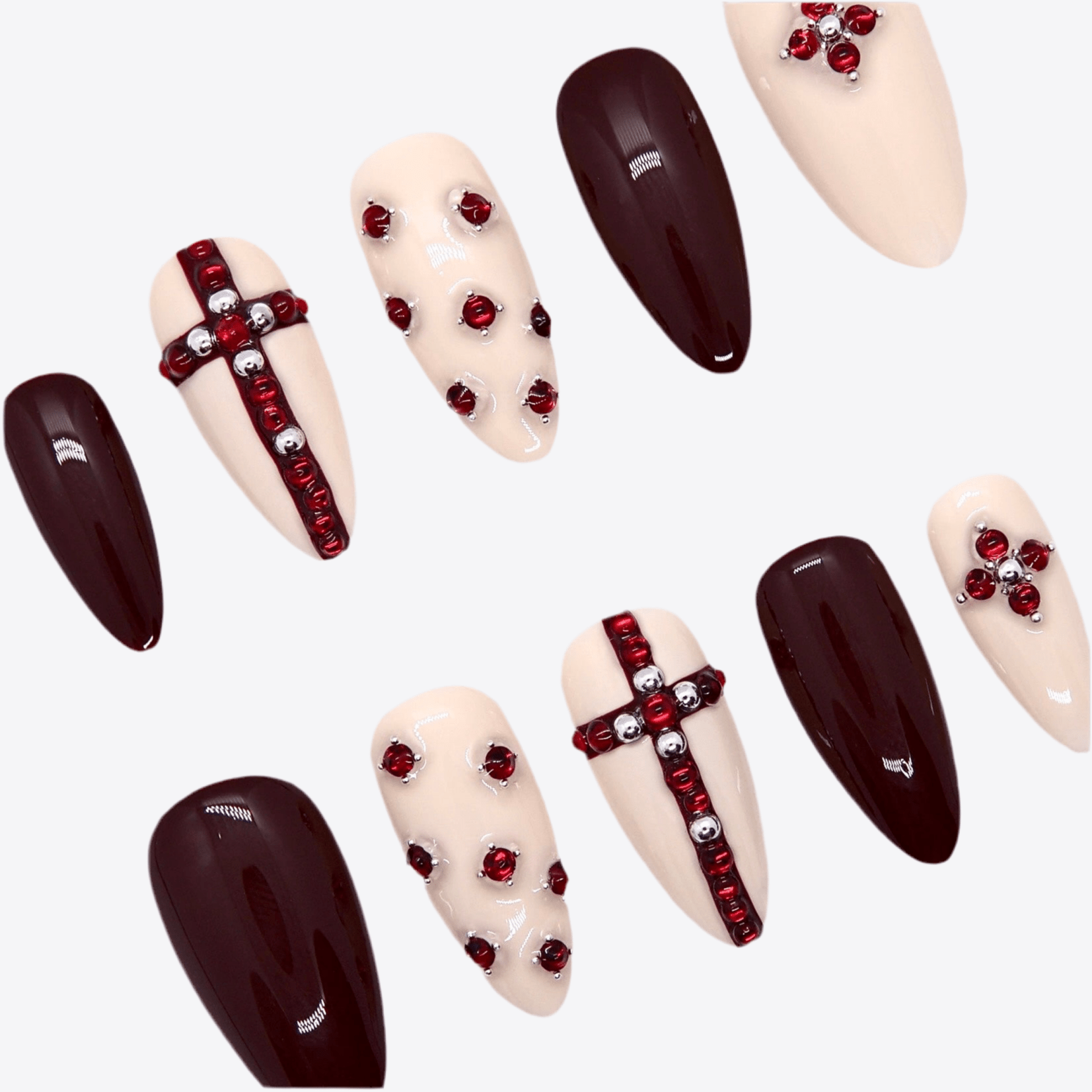 Close-up of handcrafted red gem cross on nude press-on nail